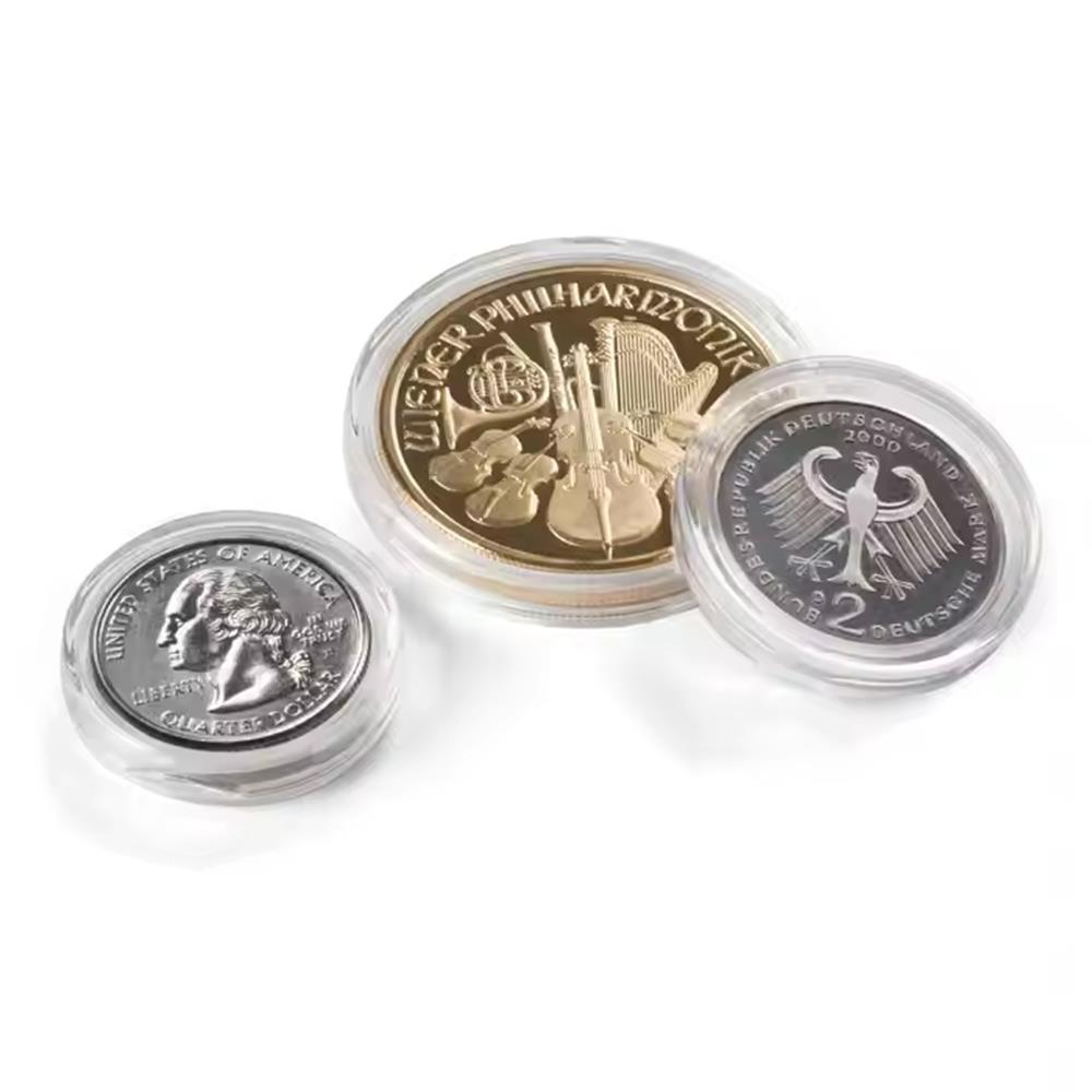 Three struck coins sealed in snap-lock clear capsules at an angle - two silver-tone faces, one gold-tone, three different diameters