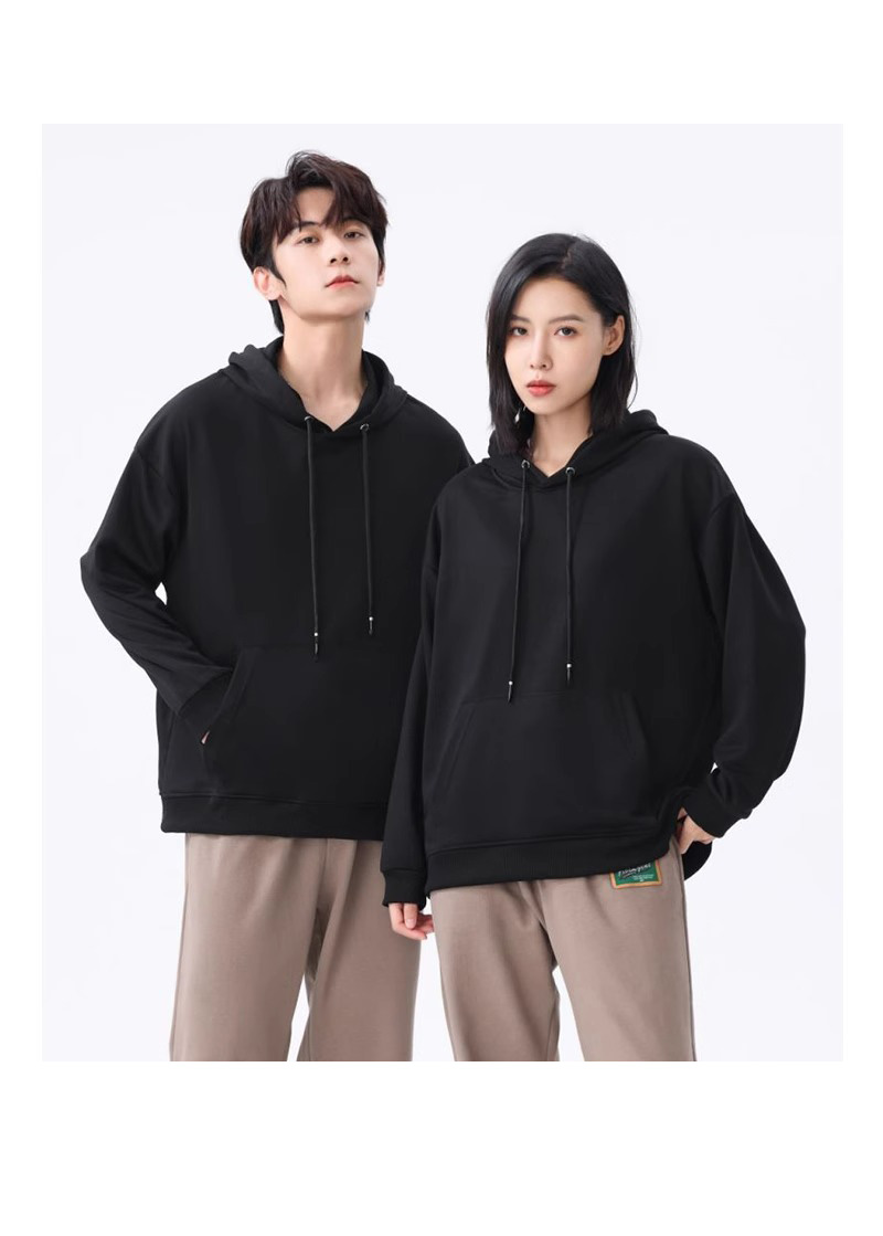 two models in matching relaxed black pullover hoodies with kangaroo pockets and silver-tipped drawcords against a white backdrop