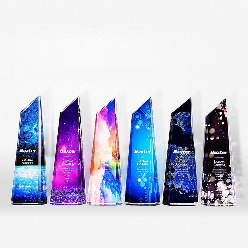 six slanted-edge acrylic award boards in a row on clear plinth feet each with a different printed background