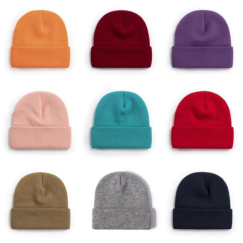 nine rib-knit cuffed beanies in orange, maroon, purple, pink, teal, red, olive, heather grey and black laid in a three-by-three grid