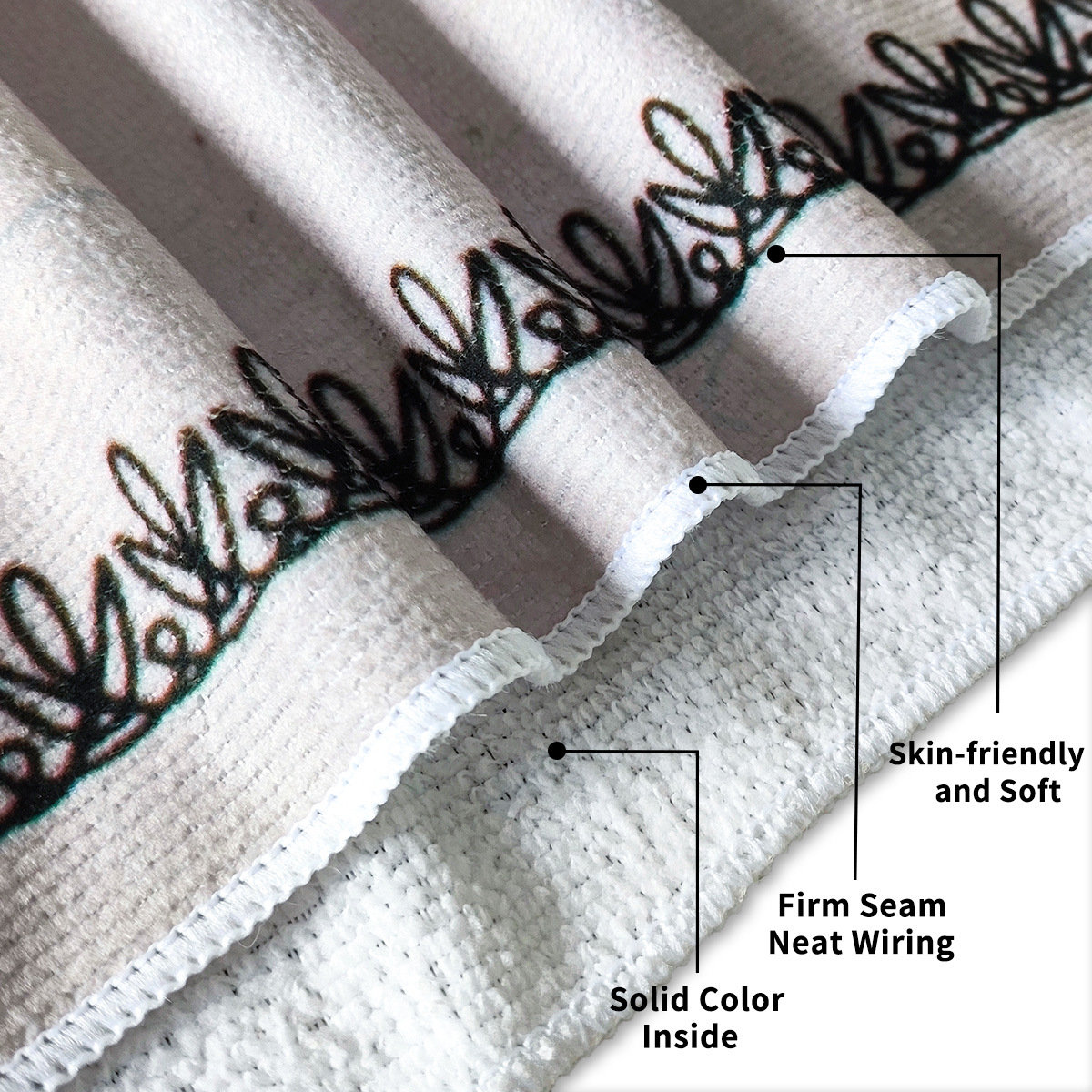 folded printed towel close-up showing smooth print face, white loop-pile reverse and overlocked seam